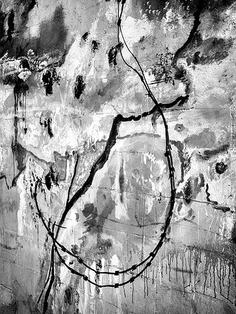 "Razor wire, concrete walls; borders defined"