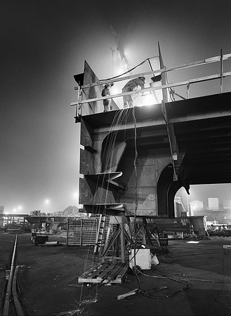"Two Workers Atop Deck Section"